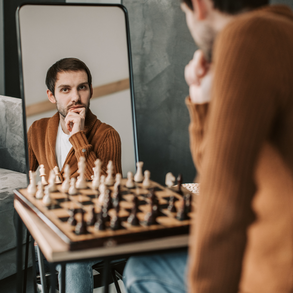 Man in Brown Long Sleeve Shirt Looking in the Mirror